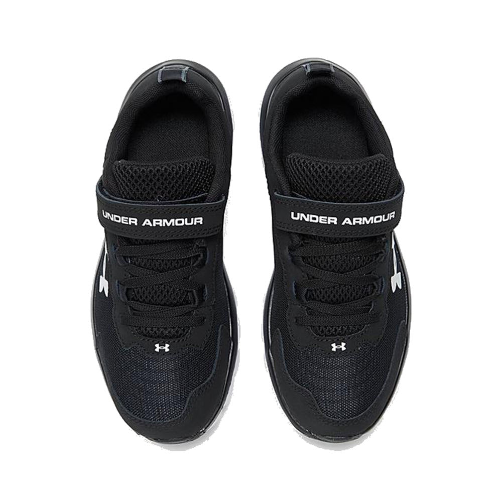A pair of black Under Armour Assert 9 Black - Kids sneakers with a lightweight mesh upper, displayed from a top-down view as a kid&#39;s athletic shoe.