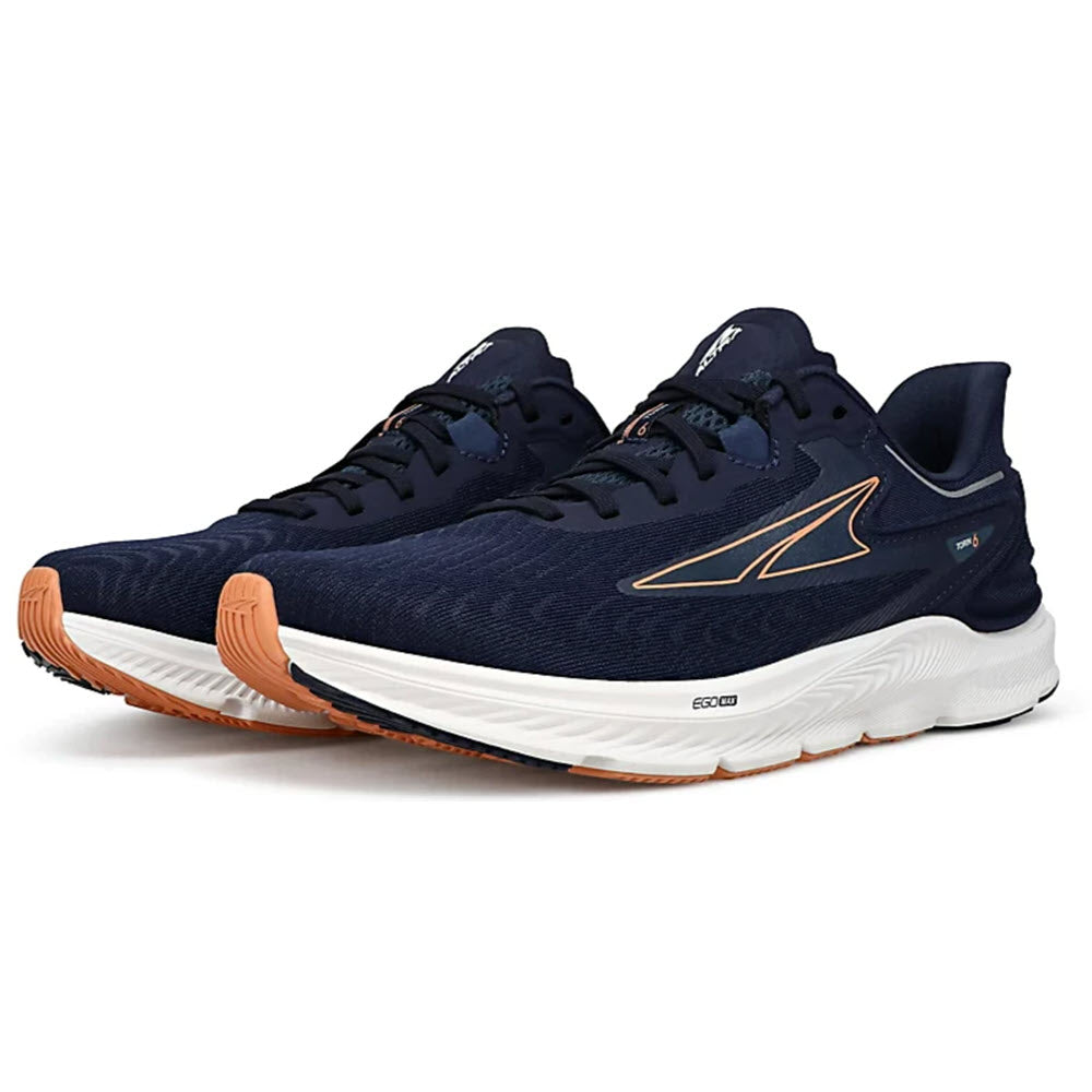 A pair of ALTRA TORIN 6 navy blue running shoes with white soles and orange accents, featuring Altra EGO™ MAX for enhanced comfort.