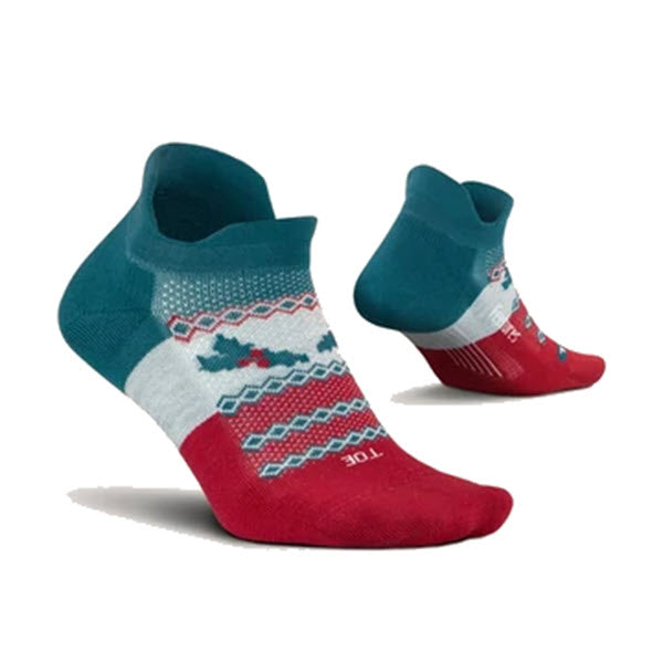 A pair of Feetures ankle-length socks with a colorful pattern on a white background, featuring targeted compression.