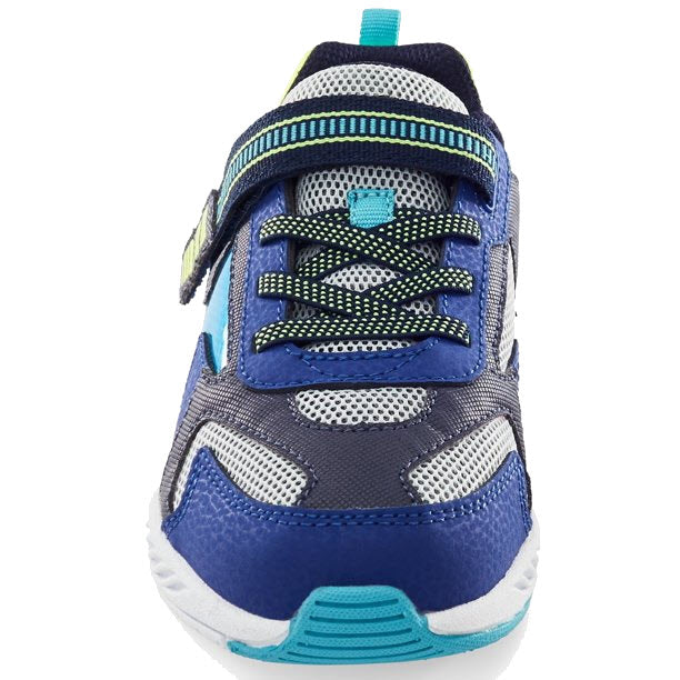 Front view of a blue and white kids shoe with green accents featuring Stride Rite Lighted Cosmic Navy Multi technology.