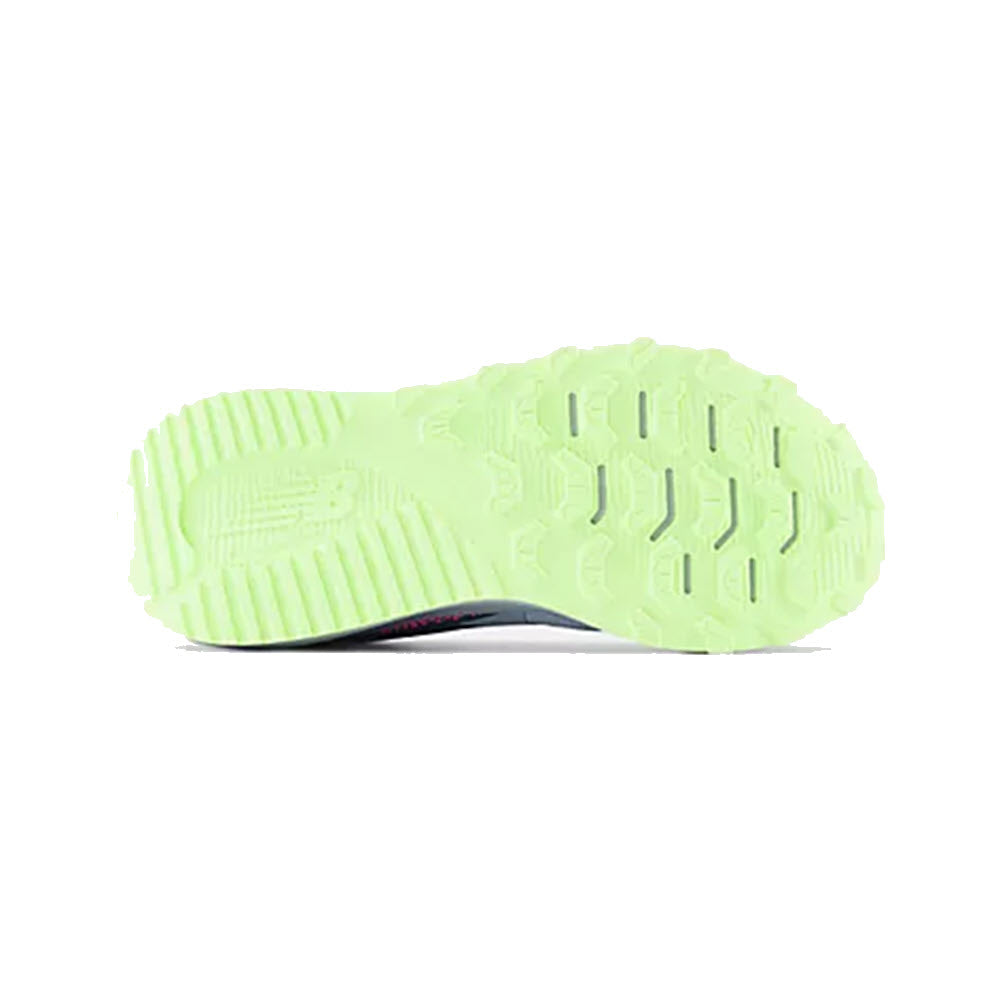 Sole of a New Balance DynaSoft Nitrel V5 Starlight - Kids running shoe showing a vibrant green tread pattern with distinct lines and shapes for traction.
