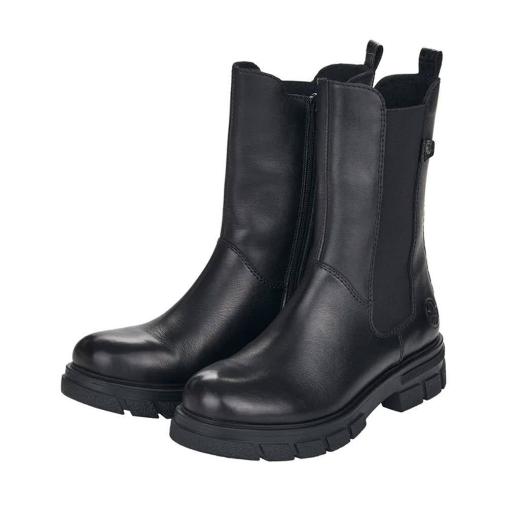 A pair of Rieker Chunky Sole Mid Height Chelsea Black boots with thick rubber soles, shown against a white background.