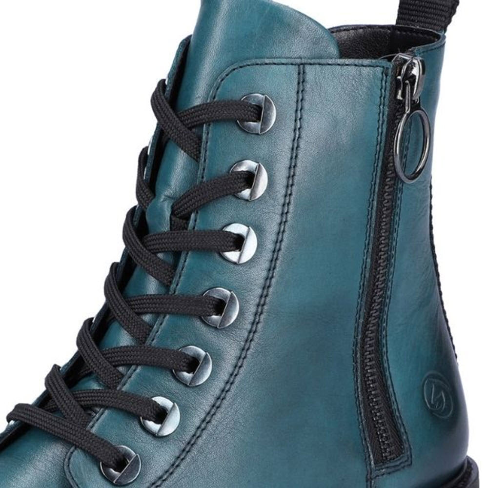 Close-up of a teal Remonte Lug Sole Combat Bootie Petrol for women with laces and a side zipper.