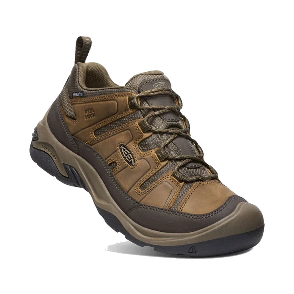 Keen Men&#39;s waterproof brown hiking shoe on a white background.