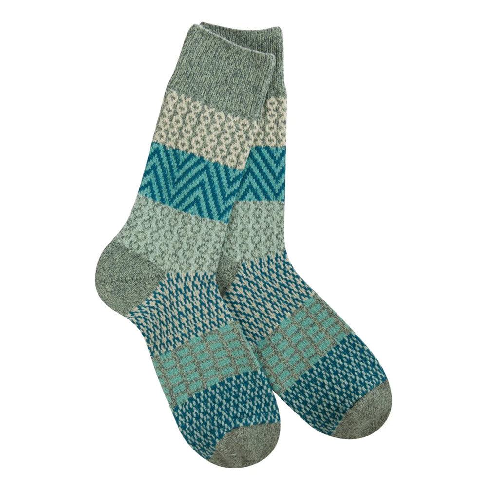 A pair of woolen socks from the Worlds Softest Collection with a patterned design in shades of green and grey, fitting women&#39;s shoe sizes 6-11.