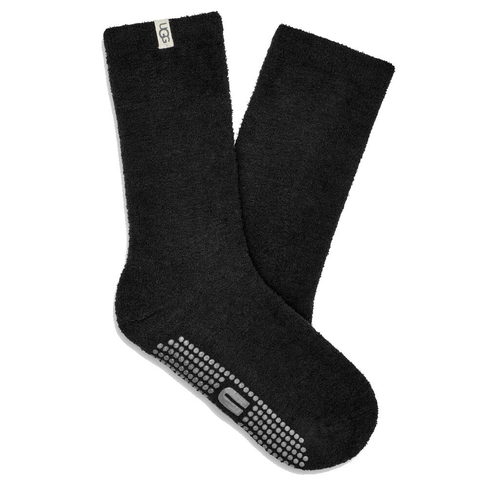 A pair of UGG PAITYN COZY GRIPPER CREW SOCKS BLACK with branded grips and logo branding on the side, perfect for lounging around the house.
