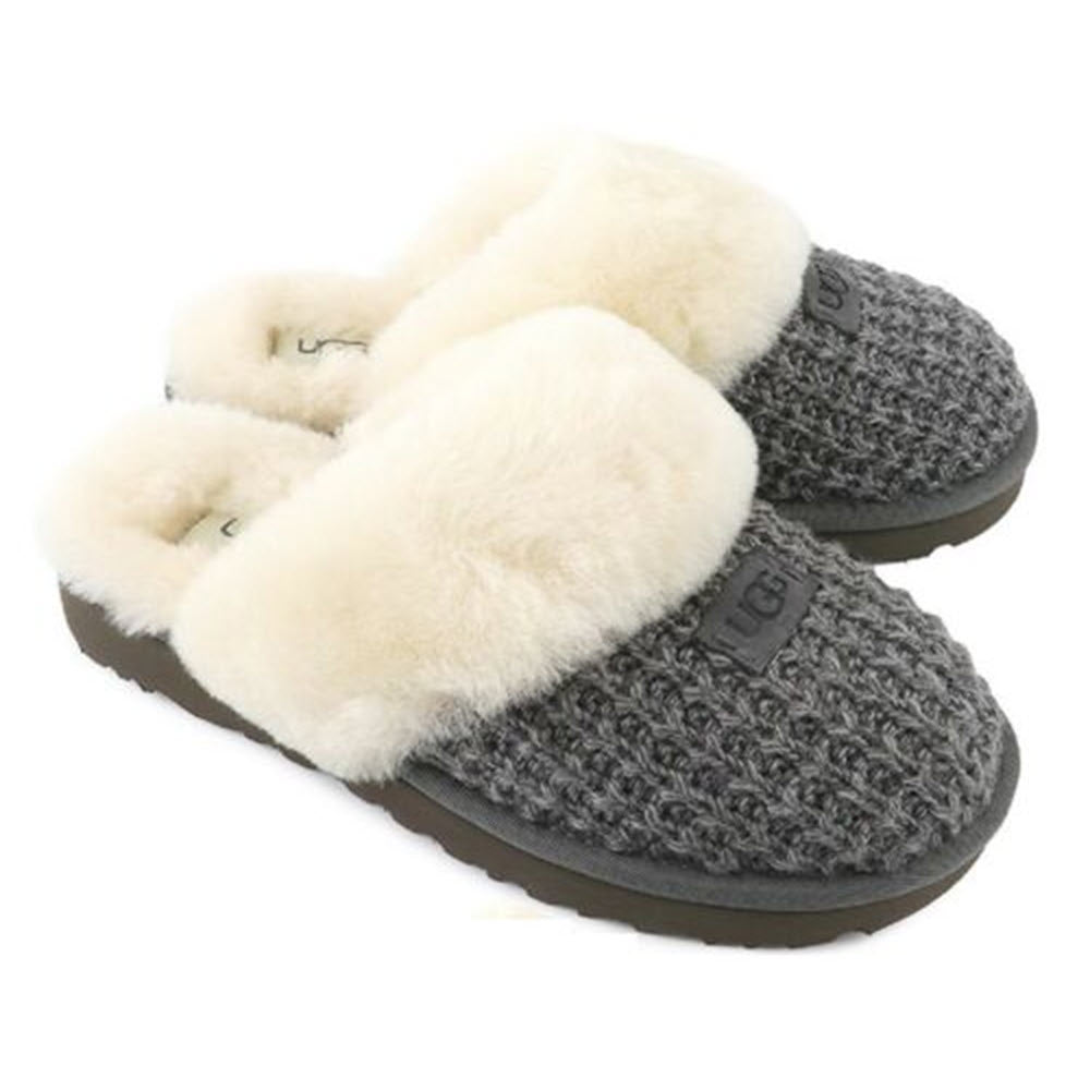 Pair of Ugg Cozy Knit Charcoal women&#39;s slippers with soft white fur lining on a white background.