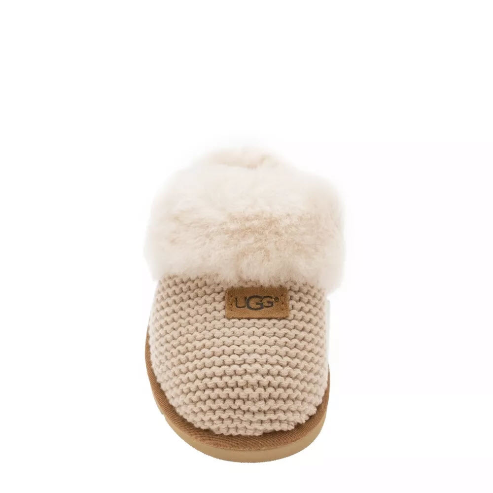Single Ugg Cozy Knit Cream slipper with sweater-knit upper isolated on a white background.