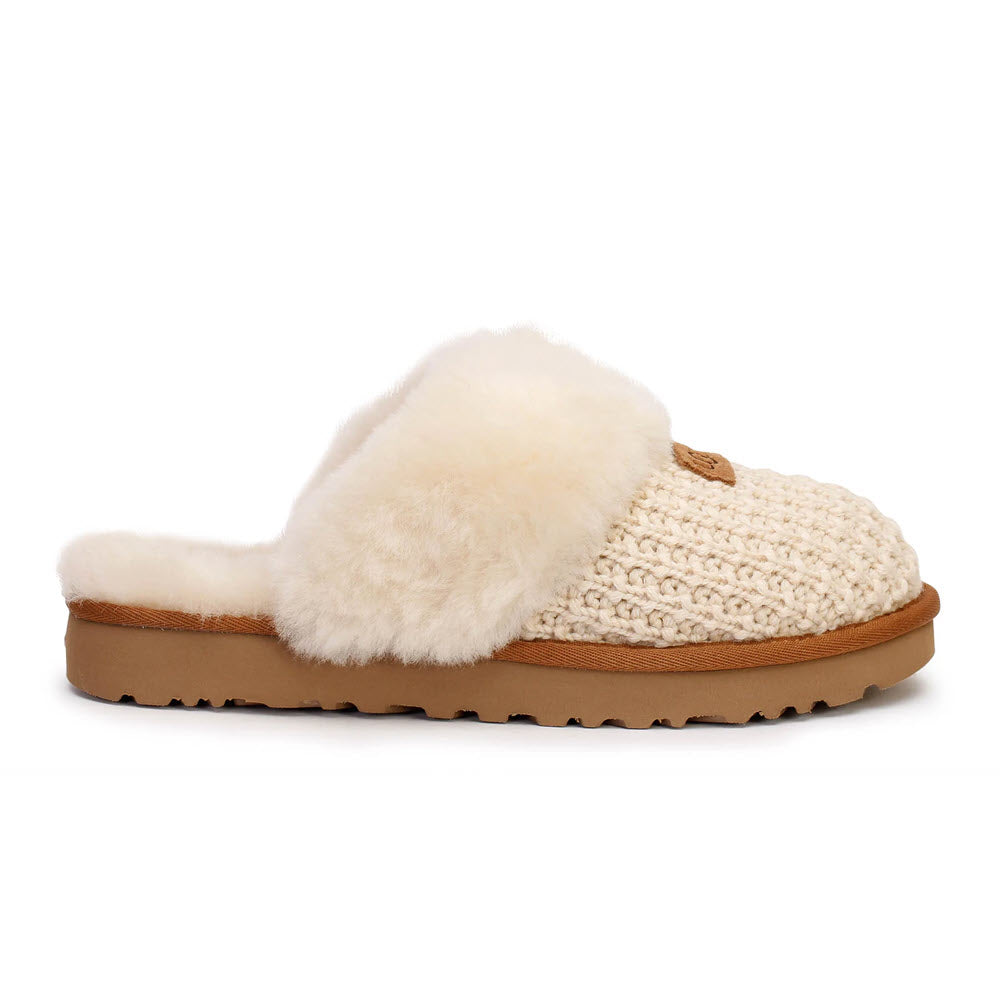 A single fluffy, outdoor-friendly Ugg slipper with a sweater-knit upper and rubber sole, isolated on a white background.