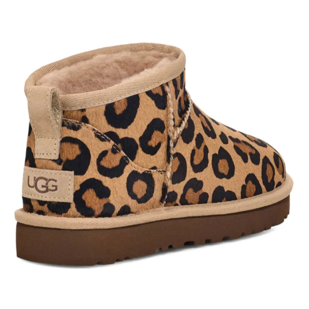 An animal-printed calf hair, ankle-high UGG CLASSIC ULTRA MINI SPOTTY NATURAL boot with a branded tag on the heel.