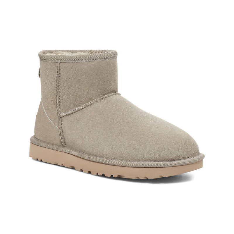 Beige suede UGG Classic Mini II GOAT ankle boot with shearling lining and a flat sole.