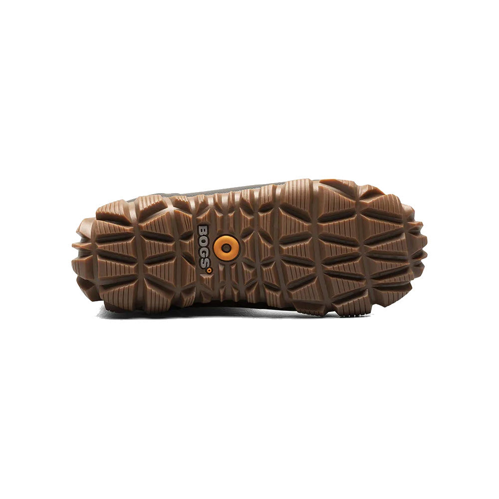 Bottom view of a brown Bogs Whiteout Faded Black - Womens winter boot showcasing its textured sole and circular logo in the center, ideal for keeping feet dry in the wettest weather.