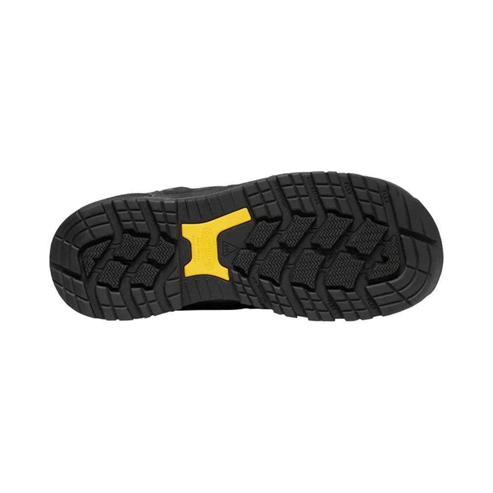 Tread pattern of a black rubber Keen Independence 6&quot; WP outsole with a yellow detail.