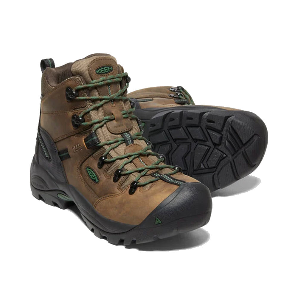 A pair of brown Keen Pittsburgh Comp Toe 6&quot; WP hiking boots with green accents and sturdy black soles, displayed against a white background.