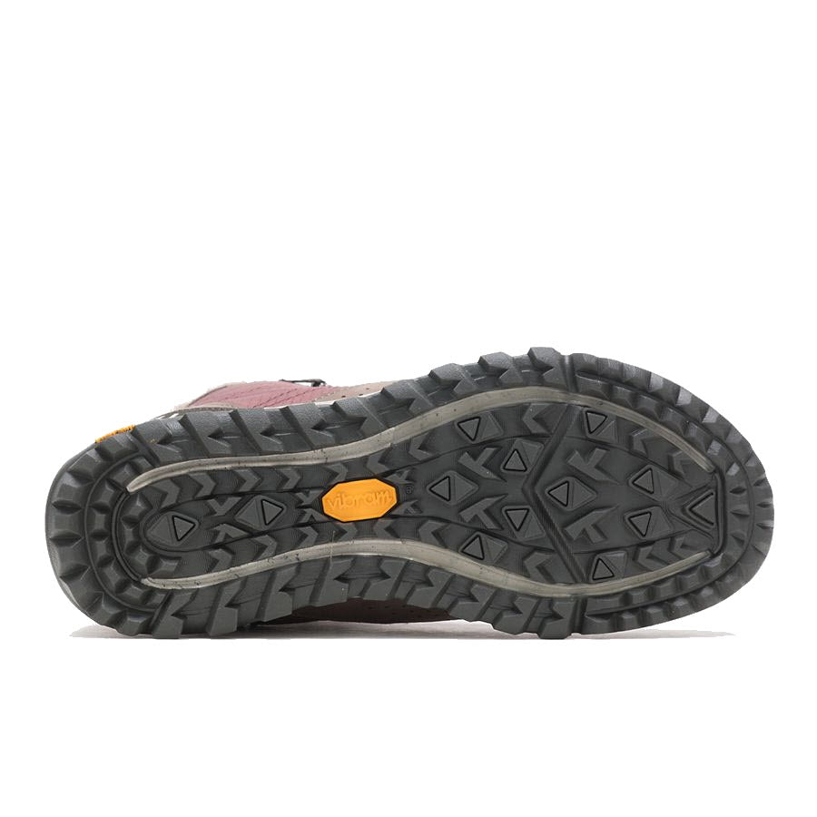 Bottom view of a gray Merrell Antora Sneaker Boot with a pink ankle collar, featuring a rugged tread pattern and a visible Vibram logo on the sole.