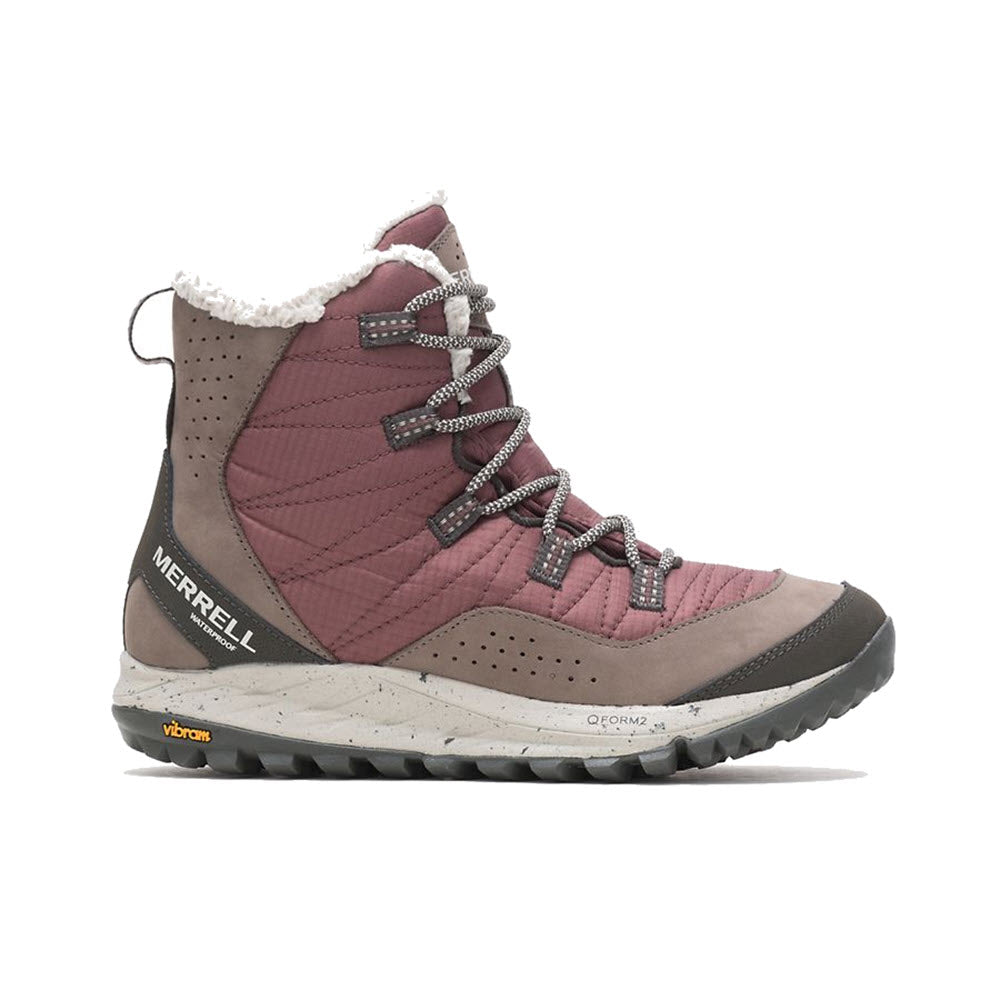Winter hiking boot by Merrell with fur lining, quilted upper, lace-up front, and Vibram sole, isolated on a white background. This MERRELL ANTORA SNEAKER BOOT MARRON - WOMENS offers sneaker-light comfort for your cold-