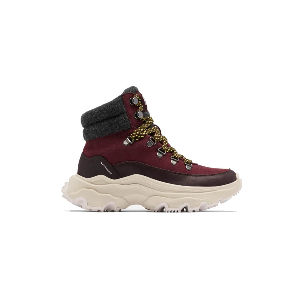 A single burgundy and gray Sorel Kinetic Breakthru Conquest WP hiking boot with thick soles displayed against a white background, offering waterproof protection.