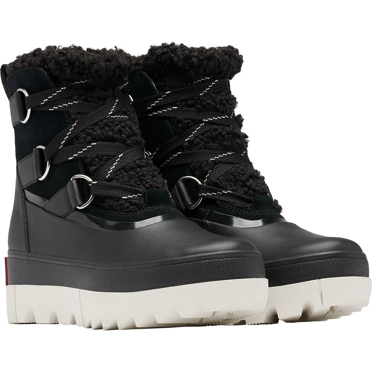 A pair of Sorel Joan of Arctic Next black winter boots with waterproof construction, featuring metallic eyelets and white stitching accents.
