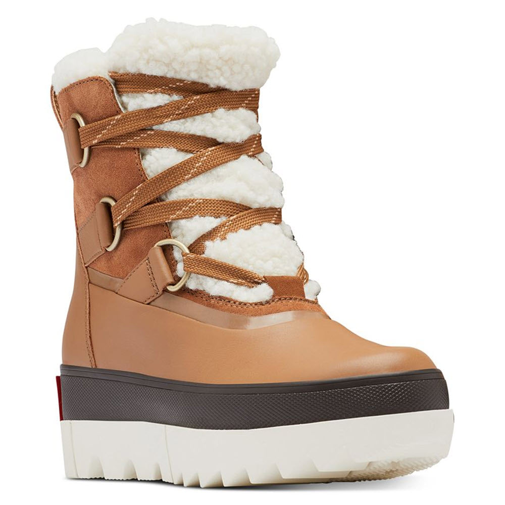Women&#39;s Sorel Joan of Arctic Next Boot Velvet Tan winter boots with brown leather upper and white faux fur lining, featuring a lace-up front and a thick, high-traction sole.