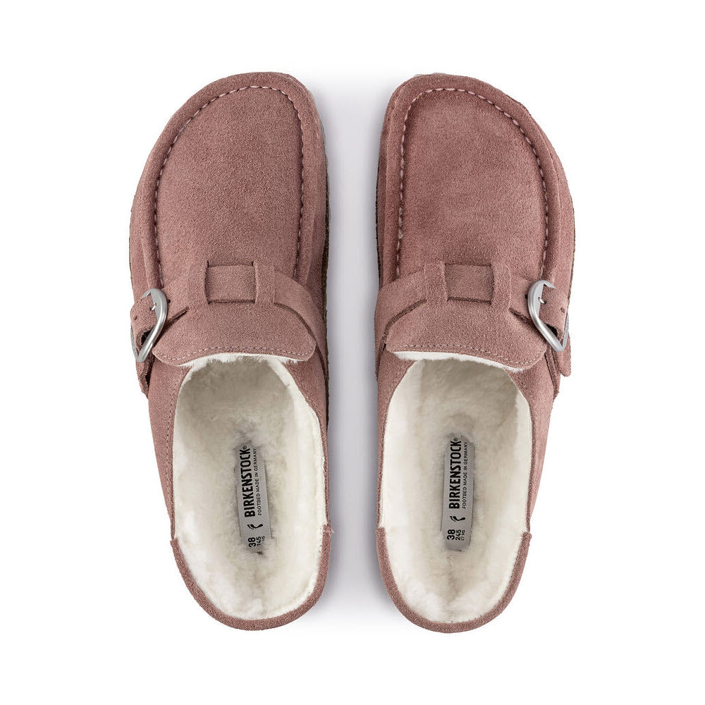 A pair of Birkenstock Buckley Shearling Pink Clay - Womens slippers with white fleece lining and visible brand labels inside, viewed from above.