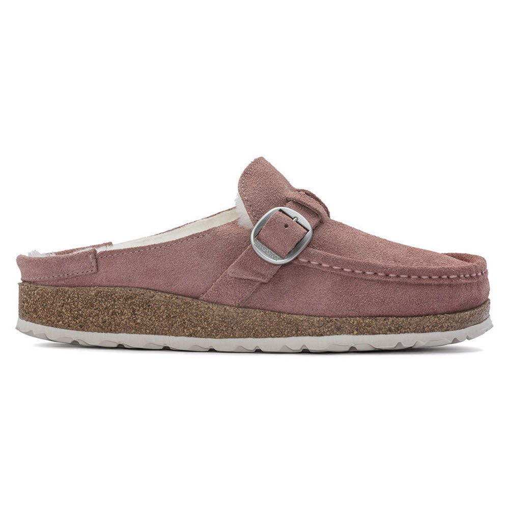 Side view of a Birkenstock Buckley Shearling Pink Clay moccasin with a buckle strap and cork footbed, isolated on a white background.