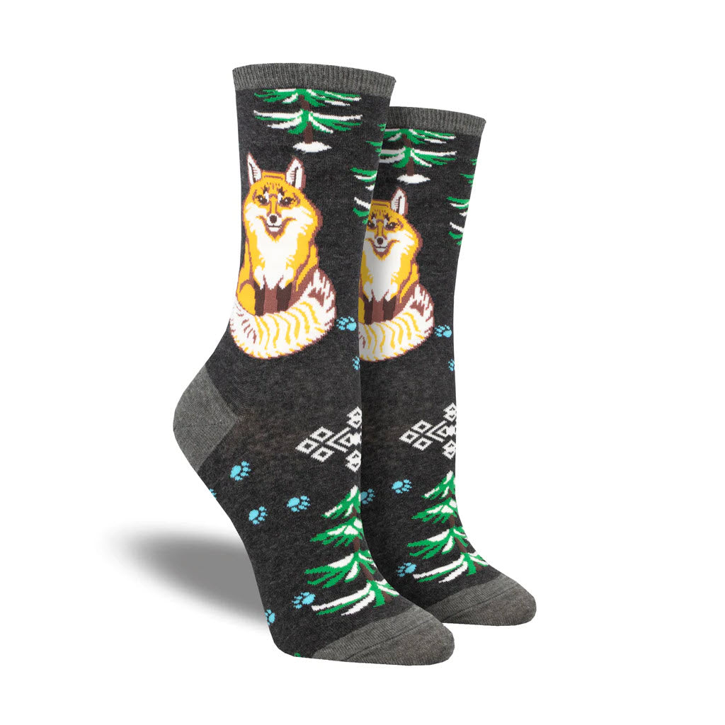 A pair of Socksmith Artic Fox socks featuring a fox design, with trees and geometric patterns on a grey background, sock size 9-11.