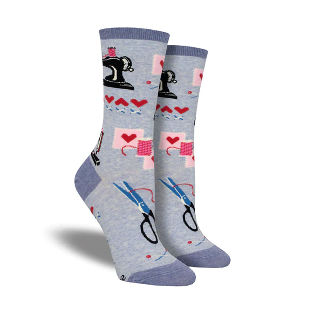 Pair of SOCKSMITH SEW IN LOVE SOCKS BLUE with a sewing motif, featuring images of sewing machines, scissors, thread, and hearts.