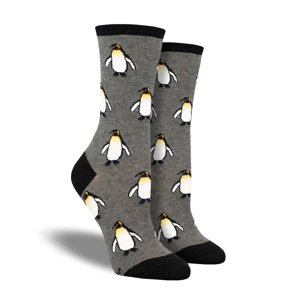 A pair of gray SOCKSMITH COOLEST EMPEROR CHARCOAL socks, featuring the tallest penguins as they dive deeper, and black toes and heels.