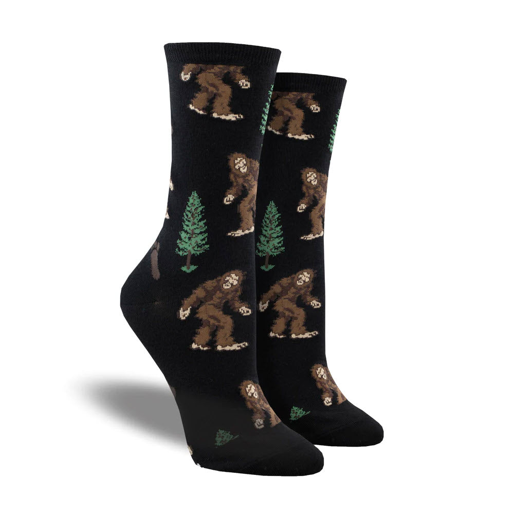 A pair of SOCKSMITH BIGFOOT SOCKS BLACK, size 9-11, with a pattern of brown bears and green pine trees.