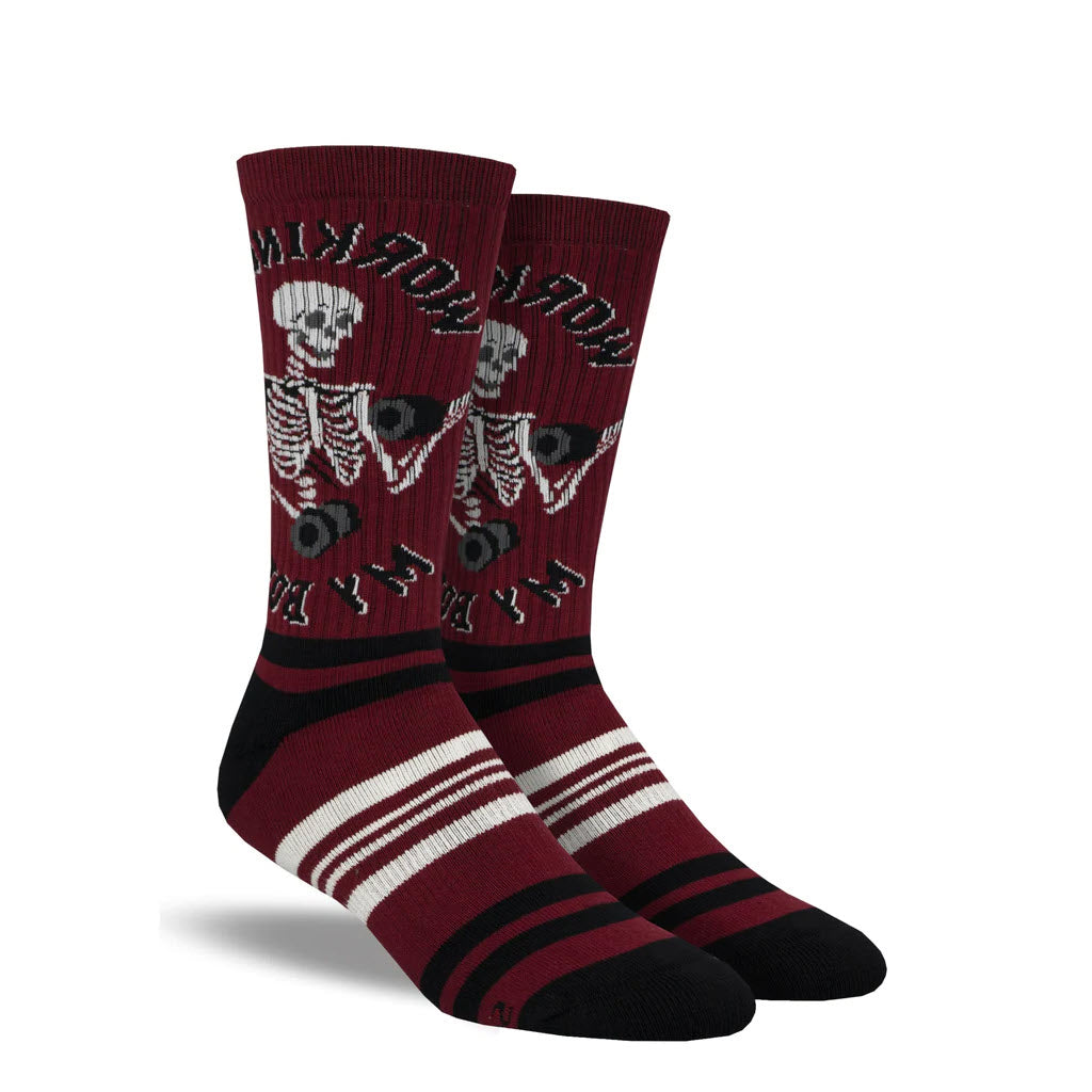 A pair of SOCKSMITH I WORKOUT CREW SOCKS RED - MENS with a skeleton design featuring a moving jaw and horizontal stripes at the toe, heel, and cuff.