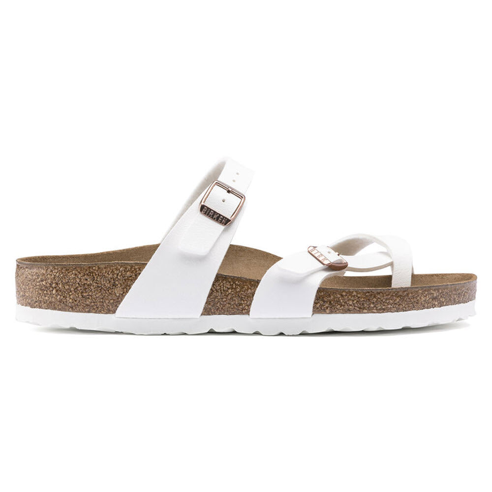 Birkenstock white single strap Mayari sandals with cork footbed and white sole on a white background.
