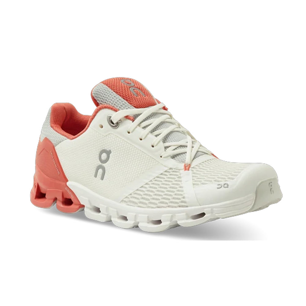 A pair of white and red On Running Cloudflyer athletic running shoes on a white background.
