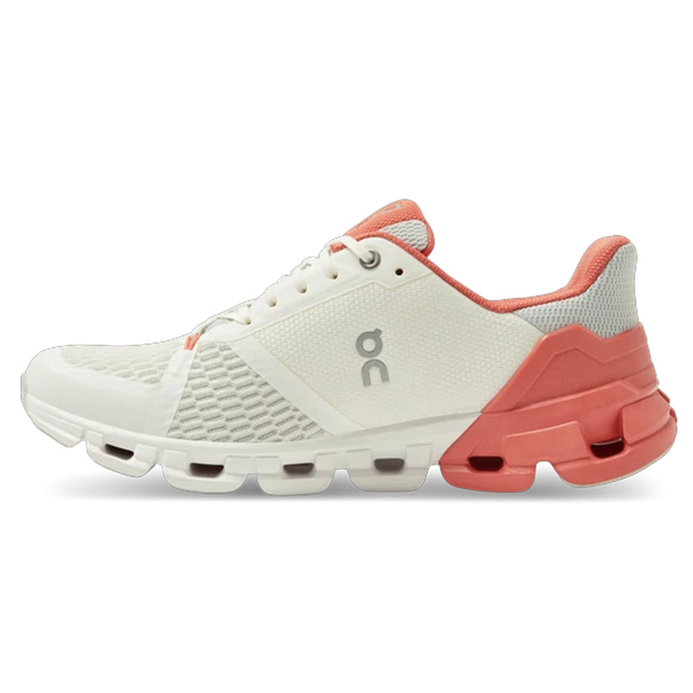 A pair of white and coral On Running Cloudflyer sneakers with a unique CloudTec® sole design, offering ultralight comfort for running.