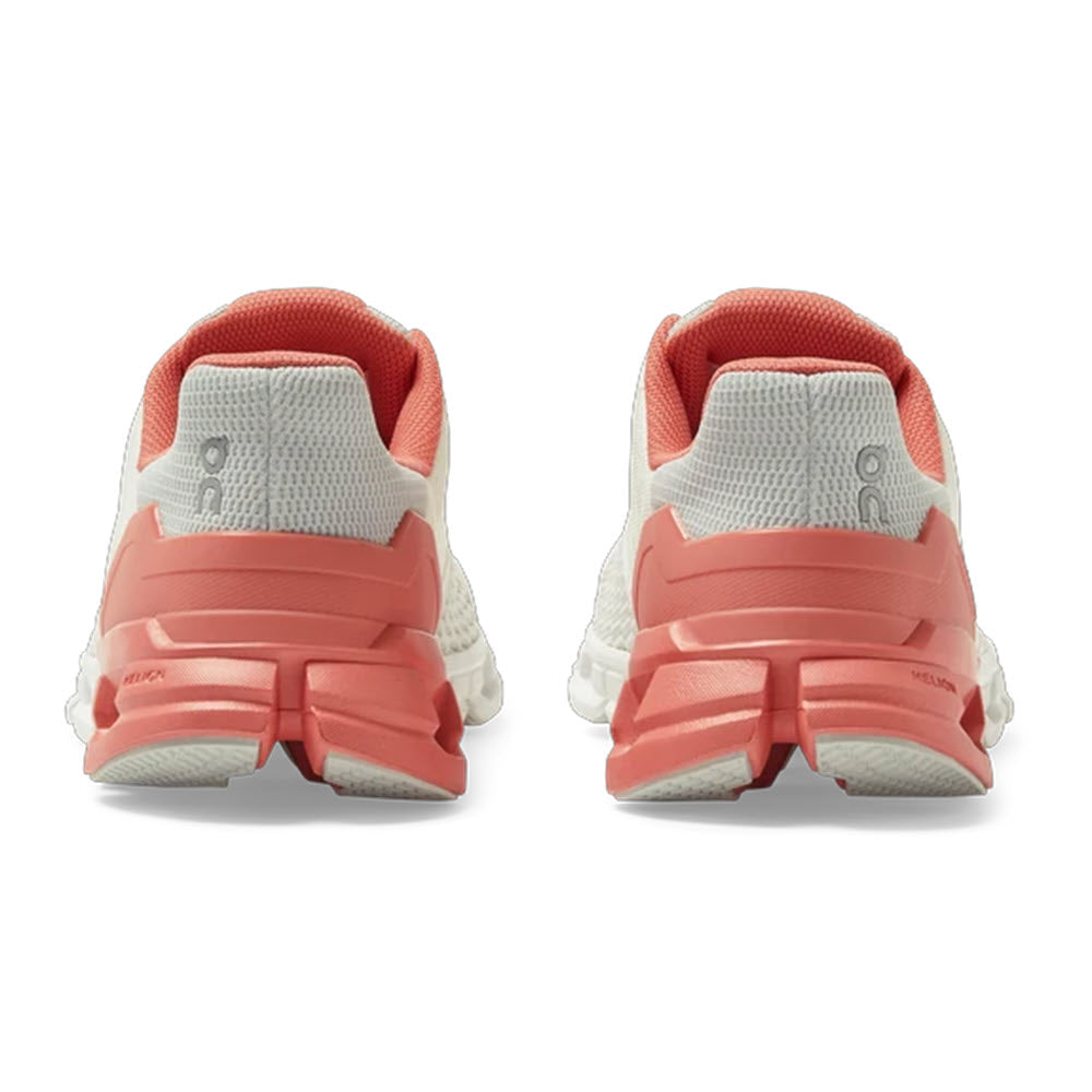 Pair of red and white On Running Cloudflyer shoes viewed from the back, featuring ultralight running CloudTec® cushioning.