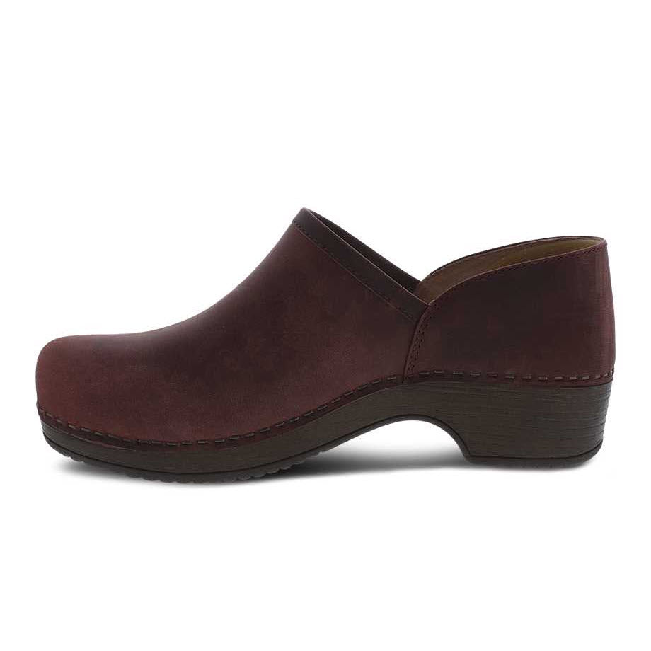 A single Dansko Brown Leather Slip-On Clog with a low heel and stitched detailing, isolated on a white background.