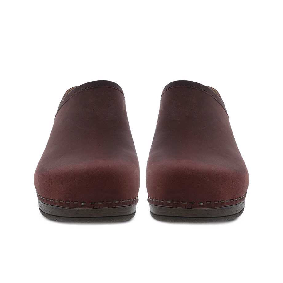 Front view of a pair of dark brown, slip-on leather DANSKO BRENNA RUBY OILED PULL UP - WOMENS shoes with visible stitching on a white background.