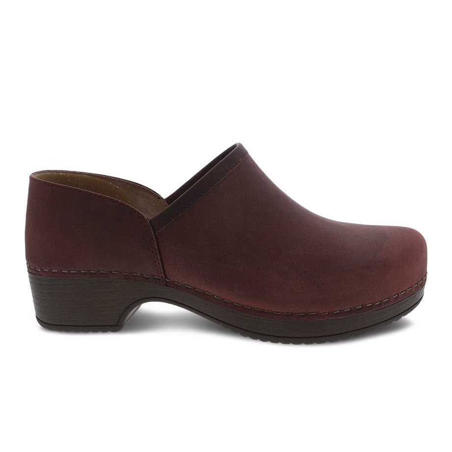 A single Dansko Brenna Ruby Oiled Pull Up slip-on clog with a low heel and rounded toe, isolated on a white background.