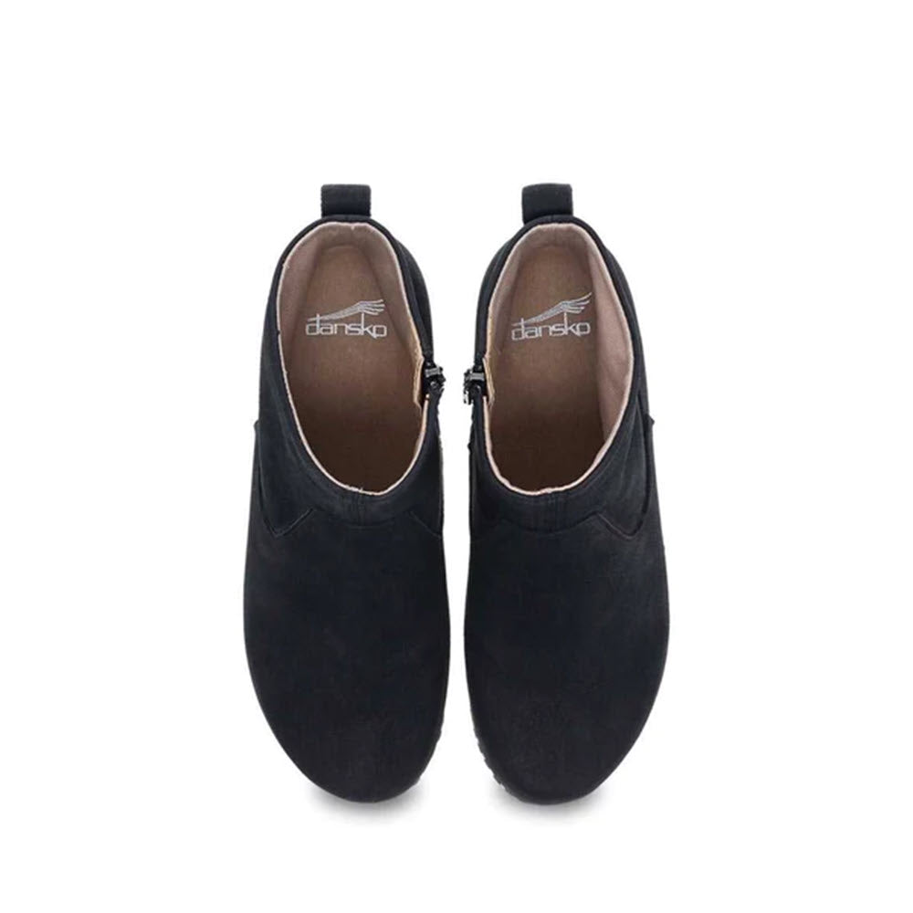 A pair of stylish bootie black Dansko Sarah clogs with nailhead trim against a white background.