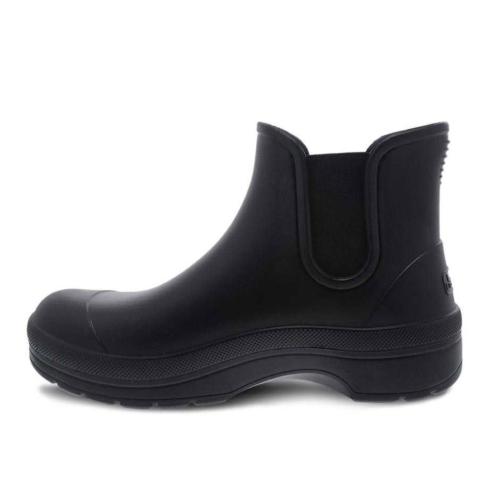 Black rubber &quot;Dansko Karmel Rain boot&quot; with elastic side panels on a white background.