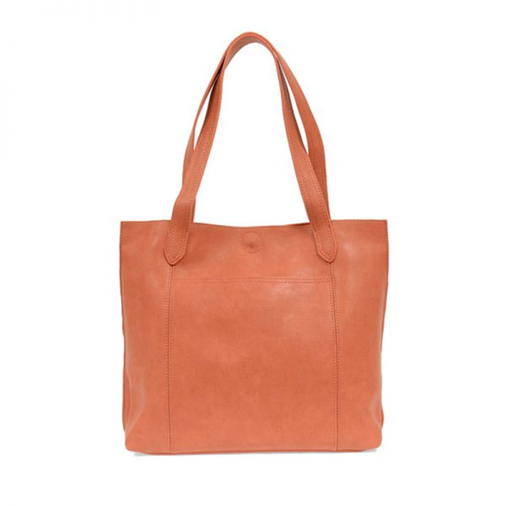 An oversized, plain tan Joy Susan Antiqued Vegan Leather tote bag with two handles.