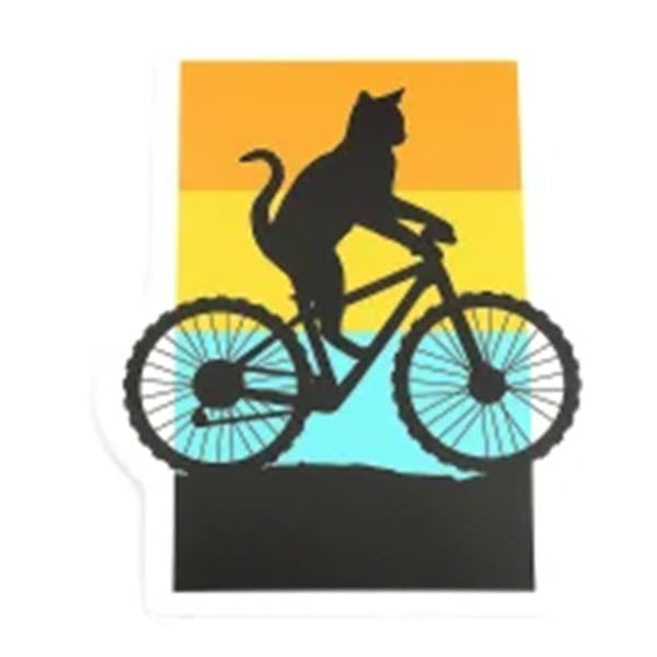 A silhouette of a cat riding a bike against a gradient sunset background, depicted on a UV protected, waterproof STICKERS NORTHWEST CAT ON BIKE STICKER.