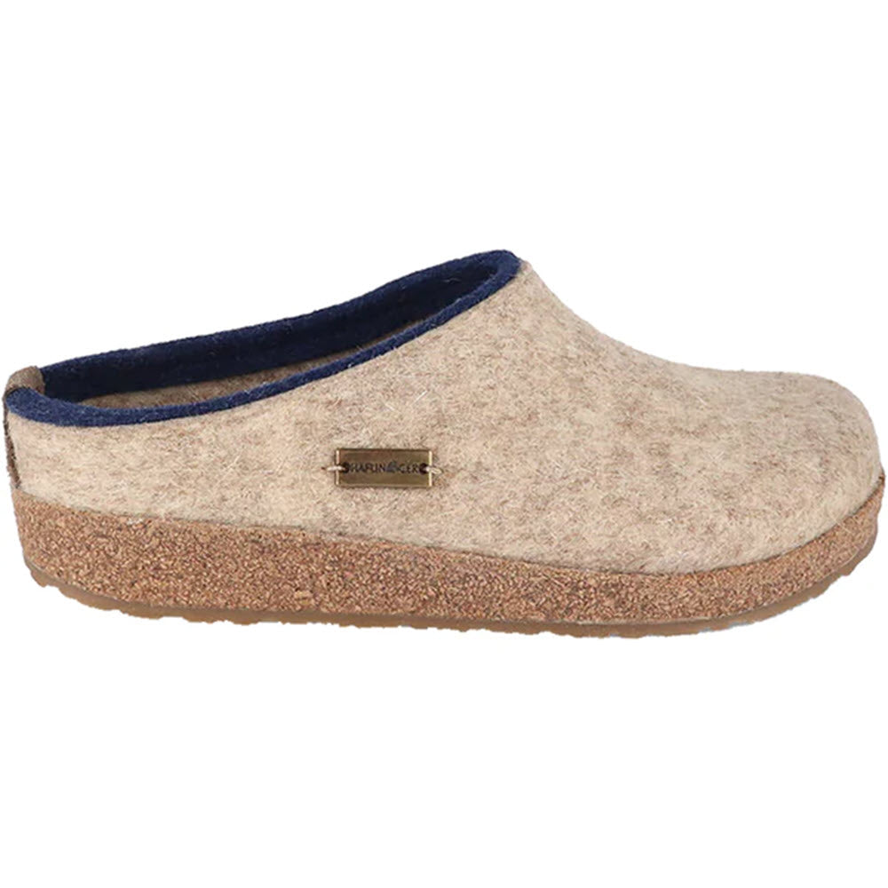 Beige boiled wool felt clog with cork and latex midsole and blue trim, known as the Haflinger Kris Tan clog by Haflingers.