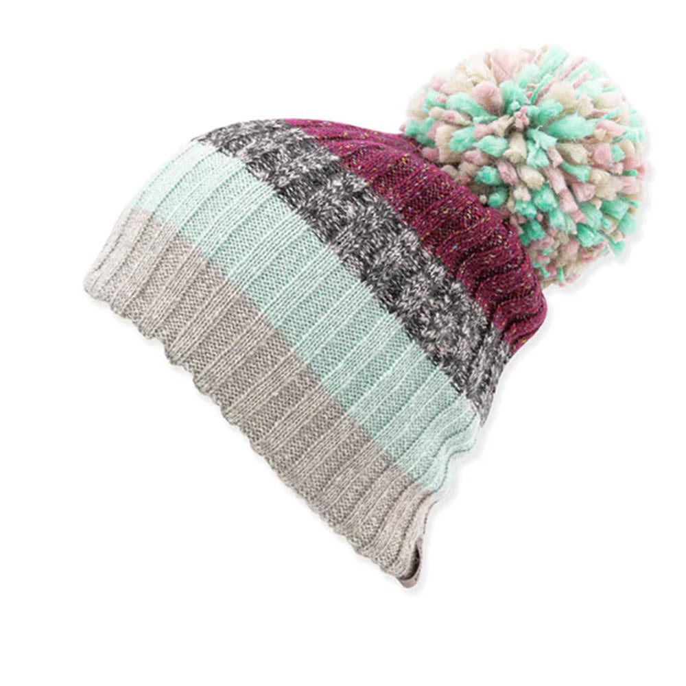 A colorful striped ribbed knit PISTIL HALLE HAT BERRY with a multicolored yarn pompom on a white background.