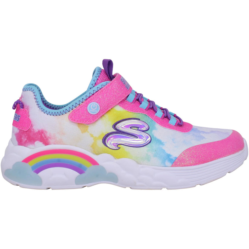 Colorful child's slip-on sneaker with rainbow and cloud designs, featuring prominent pink and blue hues and a white sole, such as the SKECHERS RAINBOW RACER PINK MULTI - KIDS by Skechers.