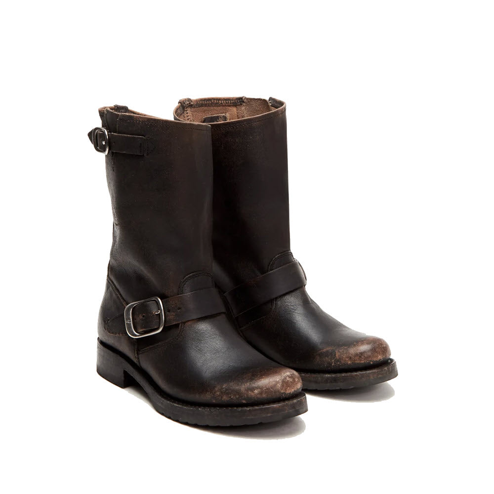 A pair of worn black Frye Veronica Short distressed leather biker boots with buckles, standing upright against a white background.