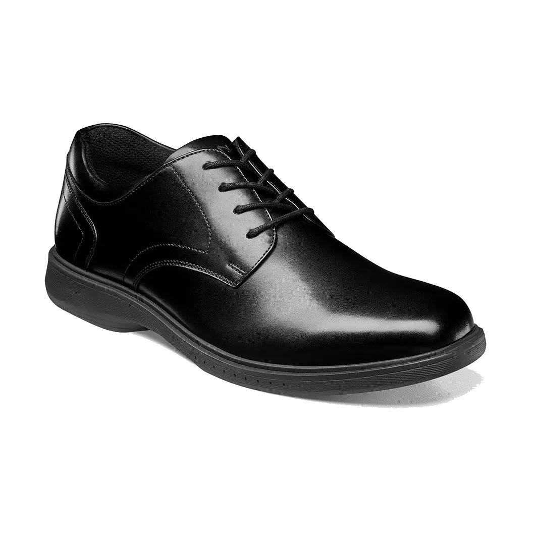 A single black leather Nunn Bush KORE Pro Plain Toe Oxford dress shoe with laces on a white background, featuring Nunn Bush KORE Pro slip-resistant technology.