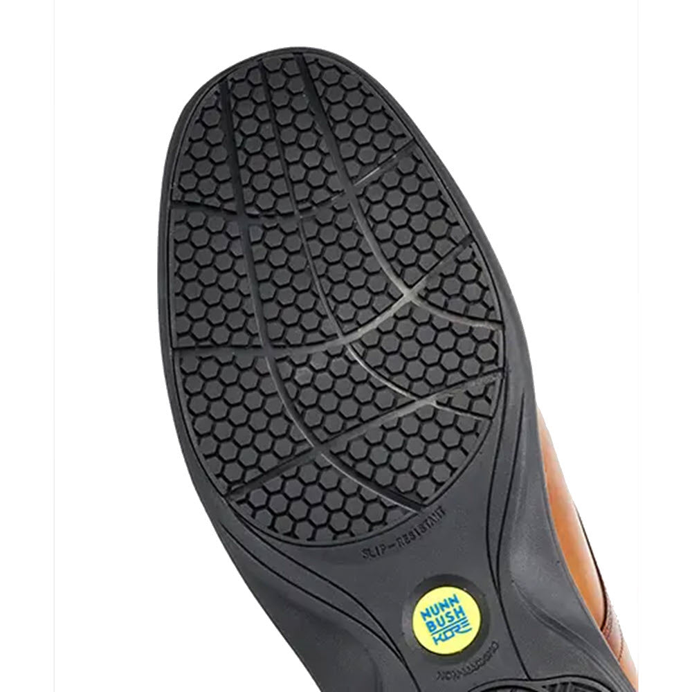 A close-up of the textured sole of a black Nunn Bush KORE Pro Plain Toe Cognac Oxford shoe with a slip-resistant label.