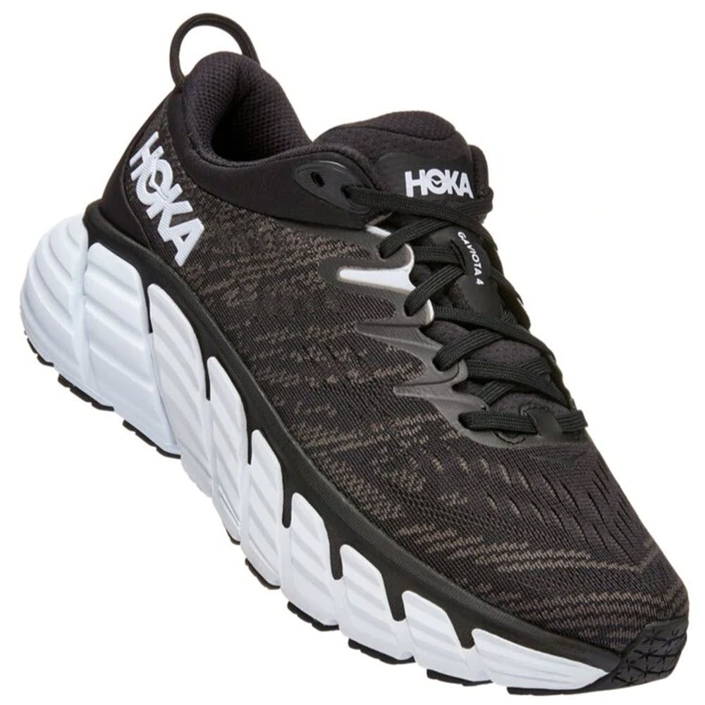 Sentence with replacement: A black and gray HOKA ONE ONE Gaviota 4 stability running shoe with a prominent white sole and enhanced with J-Frame technology.