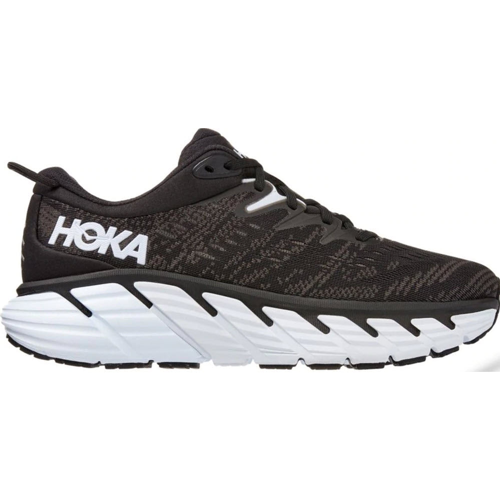 A black and white HOKA ONE ONE Gaviota 4 stability running shoe with a thick sole, featuring J-Frame technology.