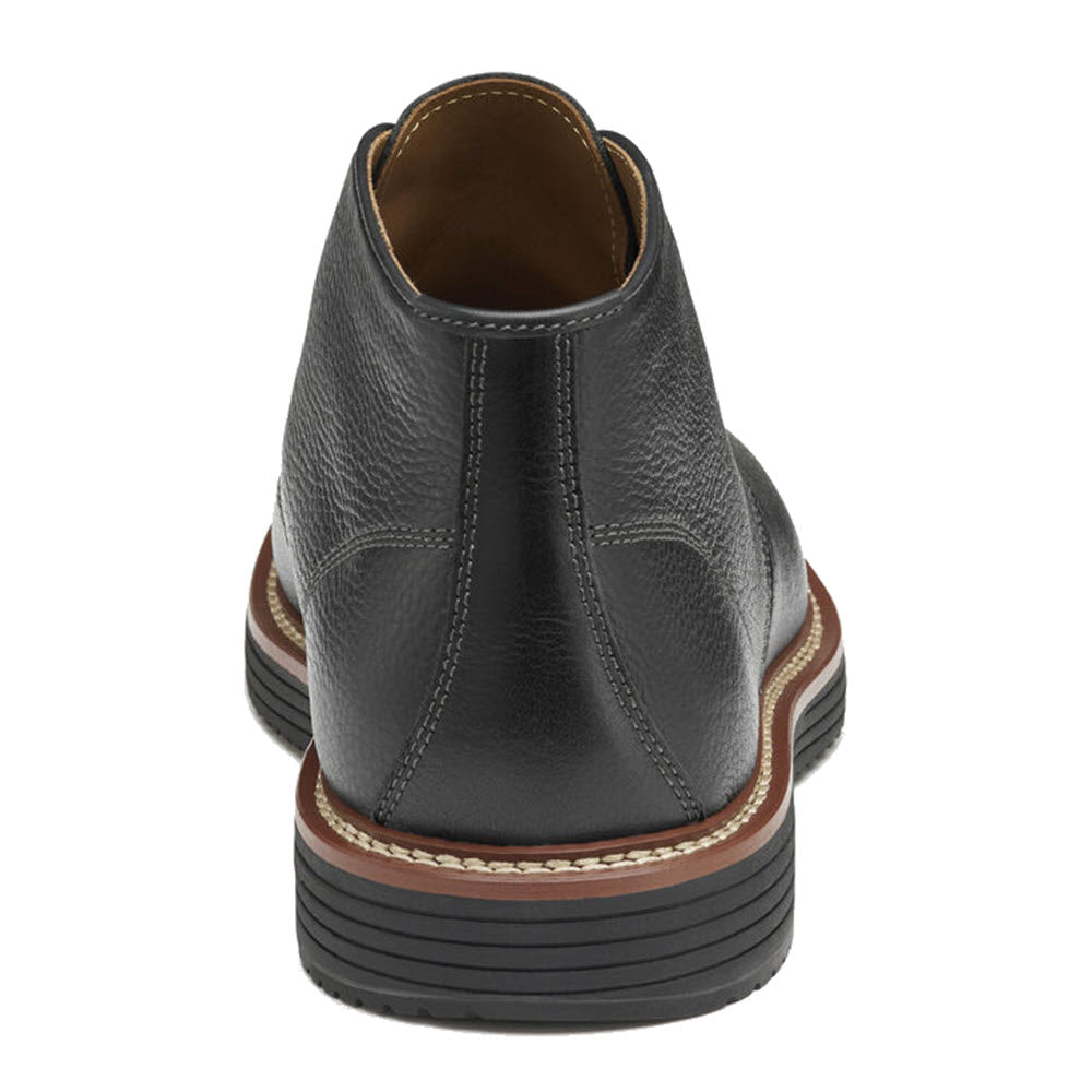 Rear view of Johnston &amp; Murphy Upton Chukka black full-grain leather dress shoes with a brown and white layered TRUFOAM™ sole, showing detailed stitching and elastic side panels.
